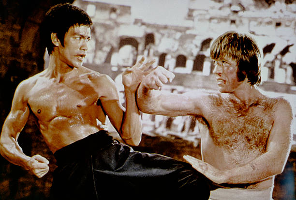 American martial artist Chuck Norris with Chinese American martial artist, actor, director and screenwriter Bruce Lee on the set of his movie Meng Long Guo Jiang (The Way of the Dragon). (Photo by Concord Productions Inc./Golden Harvest Company/Sunset Boulevard/Corbis via Getty Images)