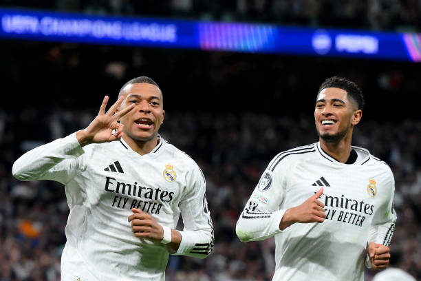 MADRID, SPAIN - FEBRUARY 19: Kylian Mbappe of Real Madrid celebrates scoring his team's third goal and his hat trick with teammate Jude Bellingham during the UEFA Champions League 2024/25 League Knockout Play-off second leg match between Real Madrid C.F. and Manchester City at Santiago Bernabeu Stadium on February 19, 2025 in Madrid, Spain. (Photo by David Ramos/Getty Images)