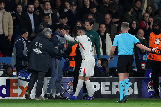Pedro Neto of Chelsea embraces a ball kid following an altercation where the ball kid was pushed by Pedro Neto during the UEFA Champions League 2025/26 Round of 16 First Leg match between Paris Saint-Germain FC and Chelsea FC at Parc des Princes on March 11, 2026 in Paris, France. (Photo by Justin Setterfield/Getty Images)