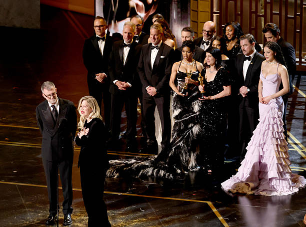 HOLLYWOOD, CALIFORNIA - MARCH 15: (L-R) Paul Thomas Anderson, Sarah Murphy, Anthony Carlino, Will Weiske, Andy Jurgensen, Teyana Taylor, Michael Bauman, Cassandra Kulukundis, Regina Hall, Shayna McHale aka Junglepussy, Leonardo DiCaprio, Chase Infiniti and Benicio del Toro accept the Best Picture award for "One Battle After Another" onstage during the 98th Oscars at Dolby Theatre on March 15, 2026 in Hollywood, California. (Photo by Kevin Winter/Getty Images)