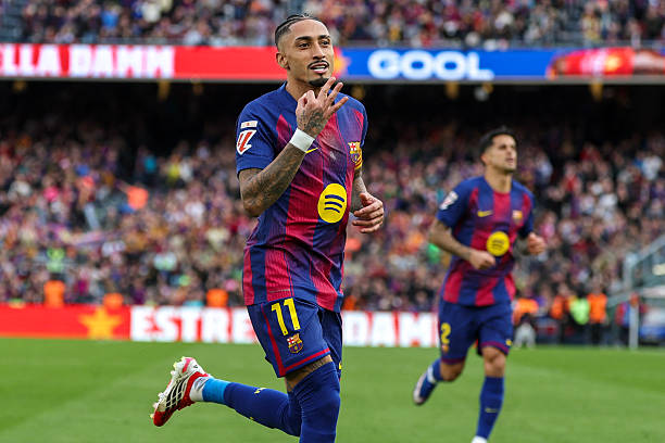 Barcelona's Brazilian forward #11 Raphinha celebrates scoring his team's fourth goal and his hat-tick, during the Spanish League football match between FC Barcelona and Sevilla FC at the Camp Nou Stadium in Barcelona, on March 15, 2026. (Photo by Lluis GENE / AFP via Getty Images)