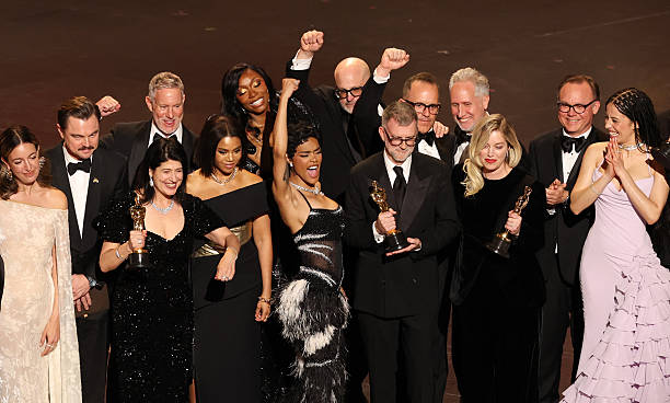 TOPSHOT - Argentine makeup artist Florencia Martin, US actor Leonardo DiCaprio, US casting director Cassandra Kulukundis, US actor James Raterman, US rapper and actress Shayna McHayle US actress Regina Hall, US actress Teyana Taylor, director of photography Michael Bauman, set designer Anthony Carlino, executive producer Will Weiske, US filmmaker Paul Thomas Anderson, US producer Sara Murphy and US actress Chase Infiniti celebrate the award for Best Picture for "One Battle After Another" onstage during the 98th Annual Academy Awards at the Dolby Theatre in Hollywood, California on March 15, 2026. (Photo by Patrick T. Fallon / AFP via Getty Images)
